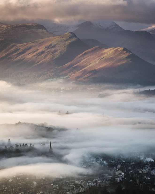 Commended: Stephen Fairbrother. A blanket of mist shrouds the town of Keswick, as viewed from Latrigg Fell in the Lake District