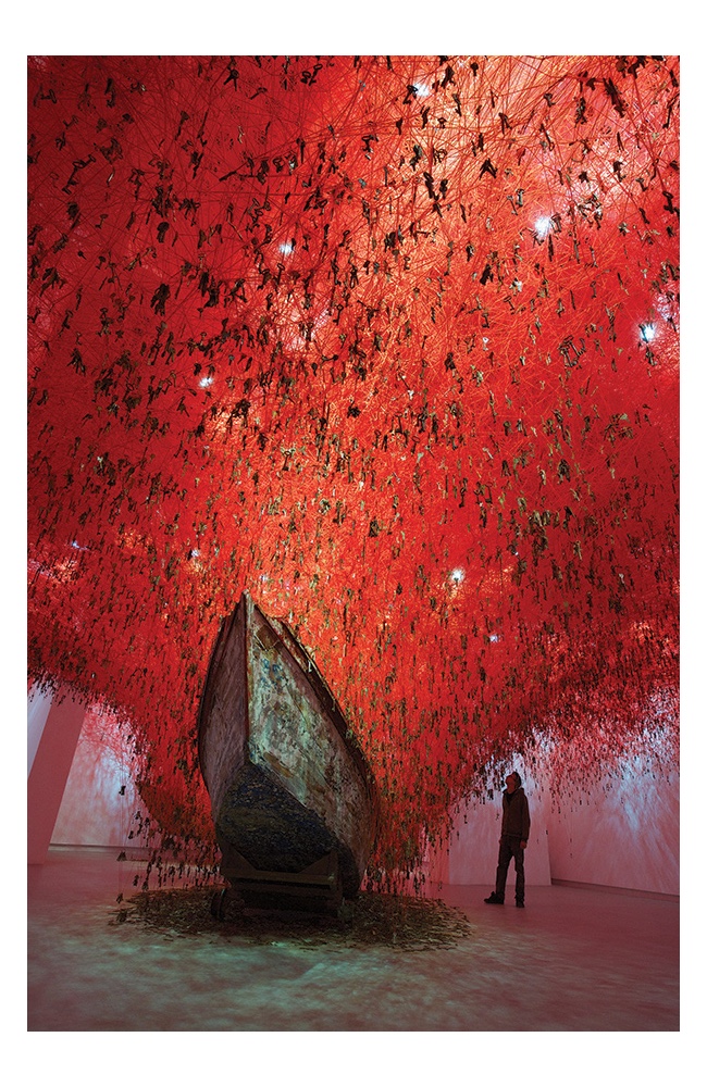 Chiharu Shiota: The Key in the Hand, 2015, old keys, old wooden boat, red yarn, dimensions variable. Japan Pavillion 56th Venice Biennale, Italy. Photo by Sunhi Mang. Courtesy of the Artist.