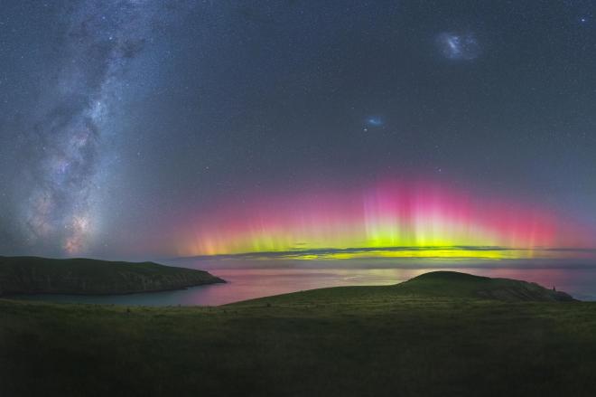 The flared up southern lights reflect bright colours on the water at Southern Bays near Christchurch, New Zealand PAUL WILSON/ROYAL OBSERVATORY INSIGHT INVESTMENT ASTRONOMY PHOTOGRAPHER OF THE YEAR